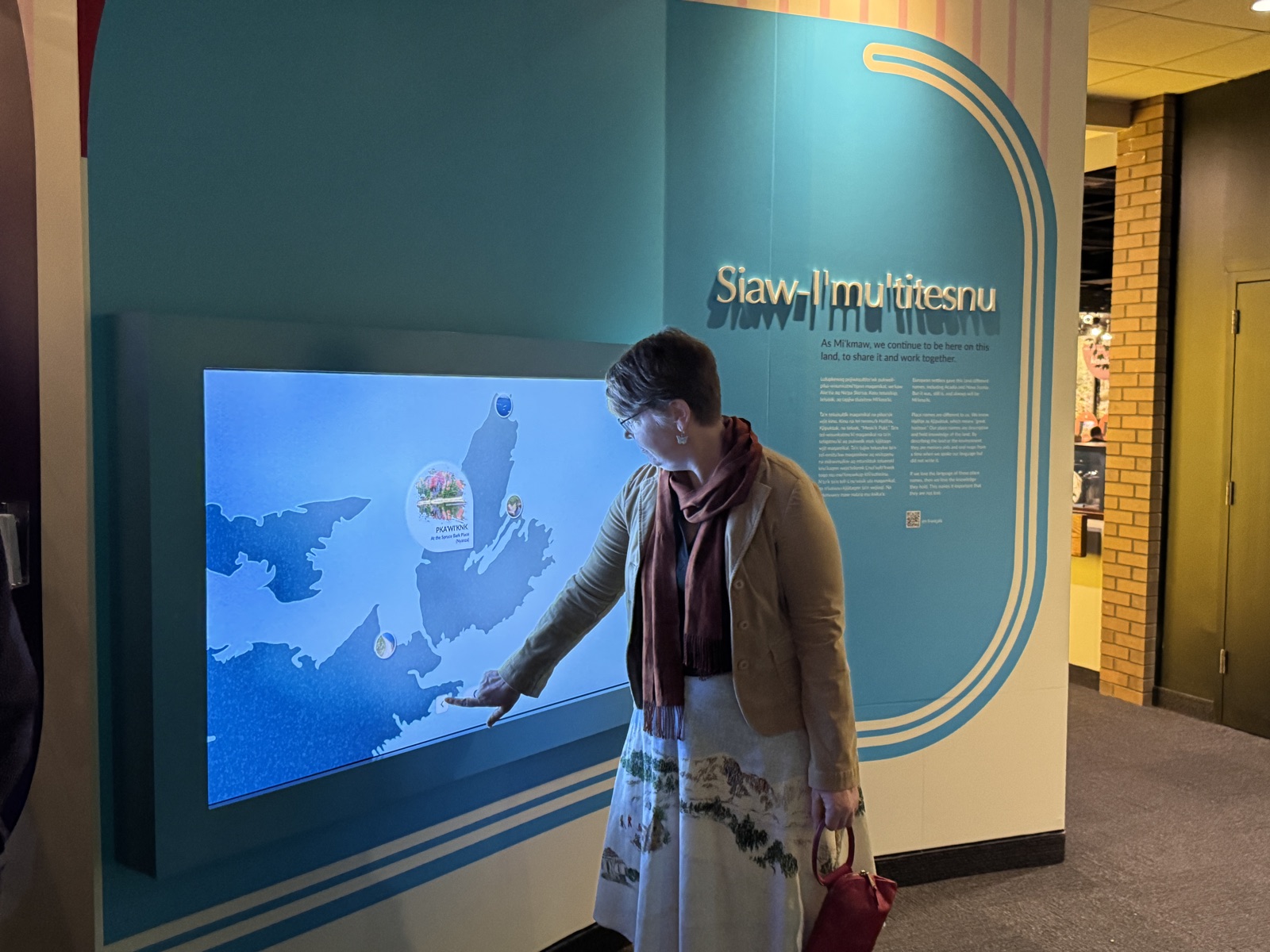 Visitor pointing at the interactive Mi'kmaki place names map
