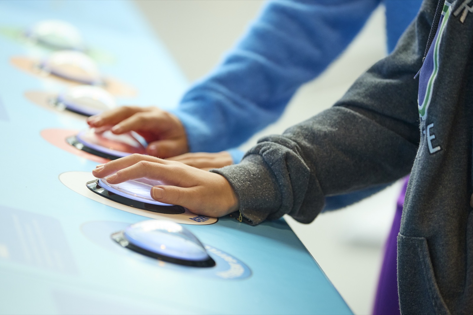 Close-up of hands on the physical sorting buttons