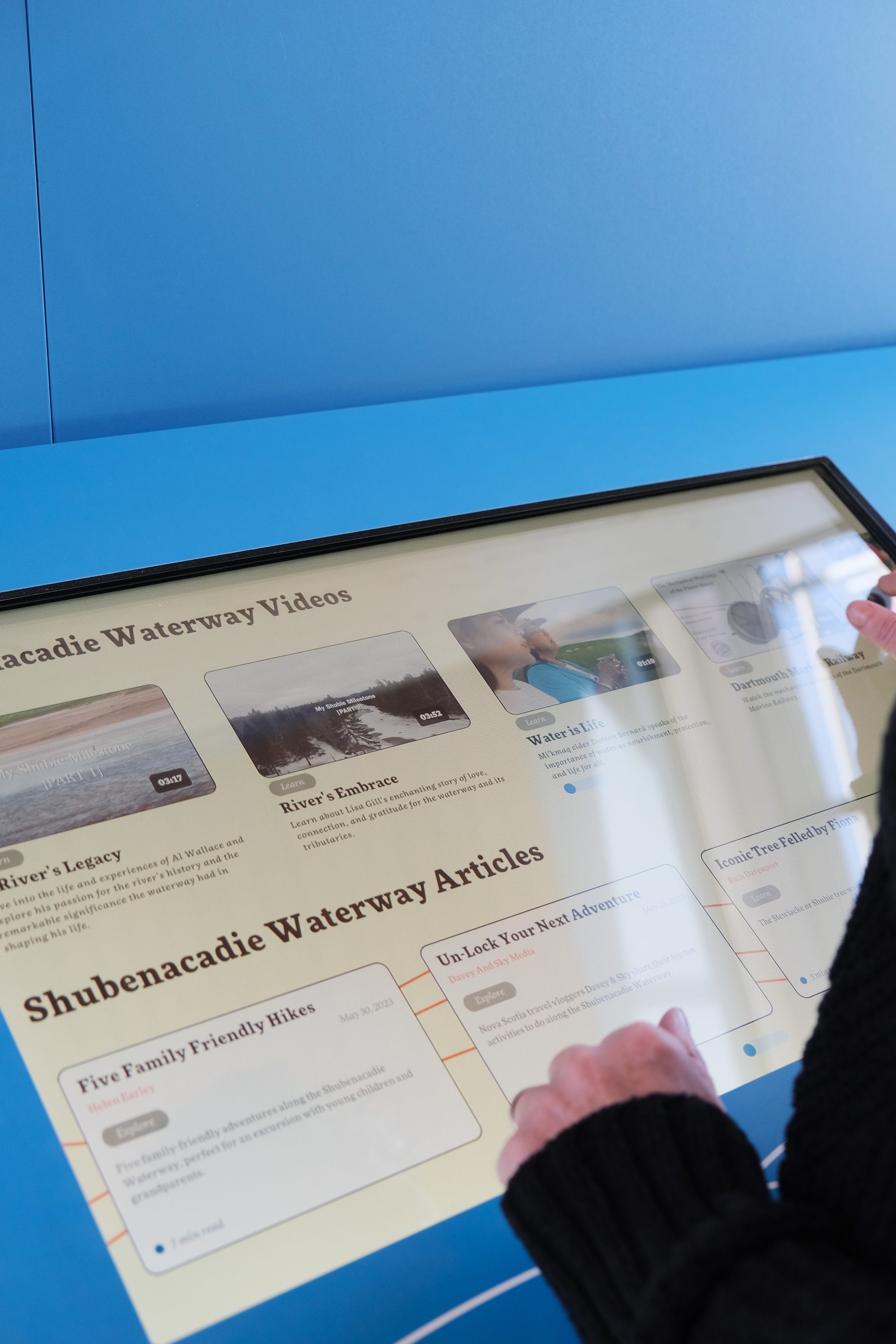 The stories touchscreen in the centre showing Shubenacadie Waterway Videos and Shubenacadie Waterway Articles