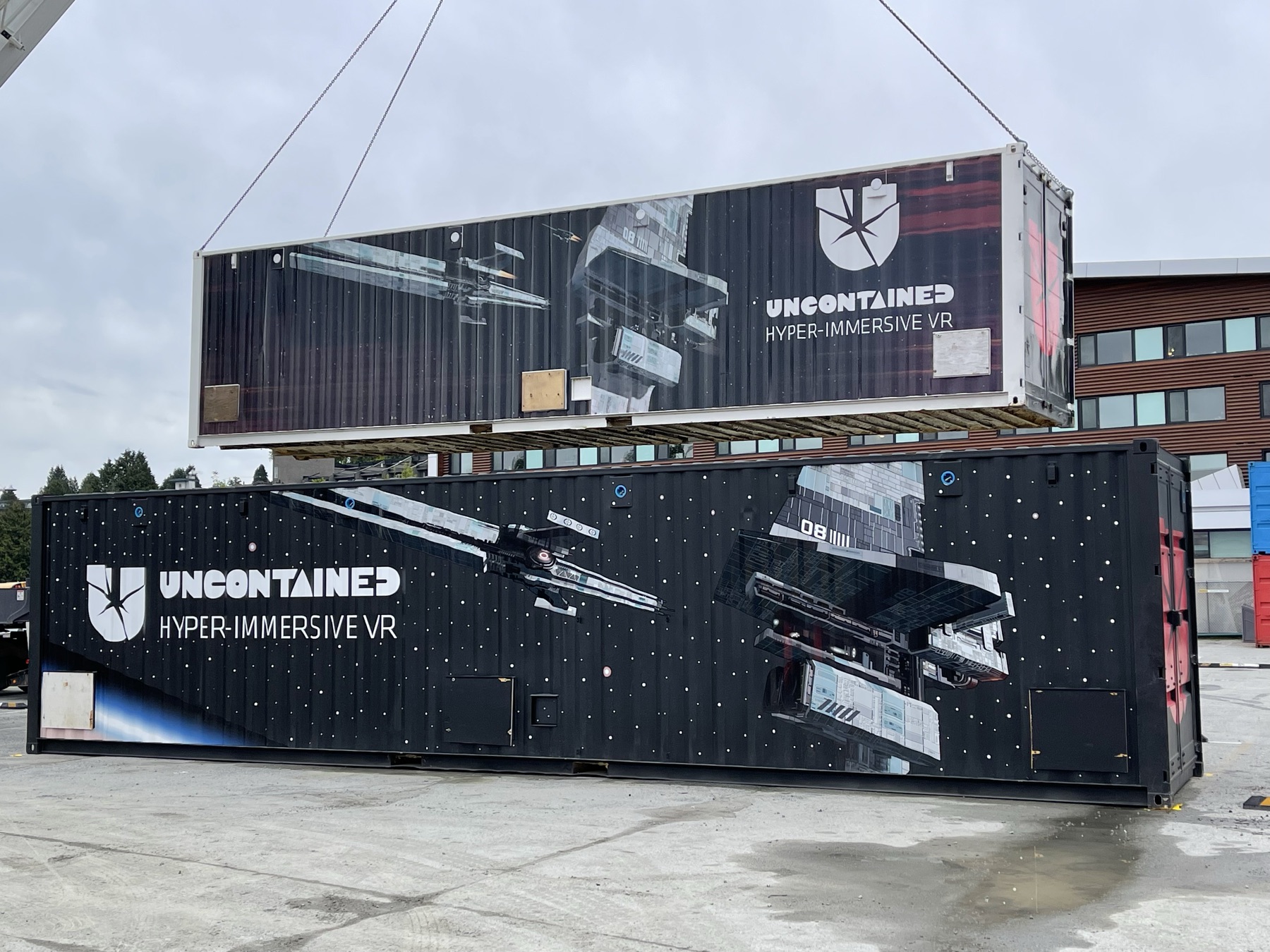 The prototype Uncontained container being craned above the finished production container