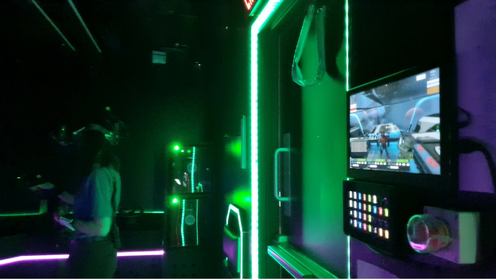 The operator station installed in the bay, showing the button panel and a monitor with the live game view