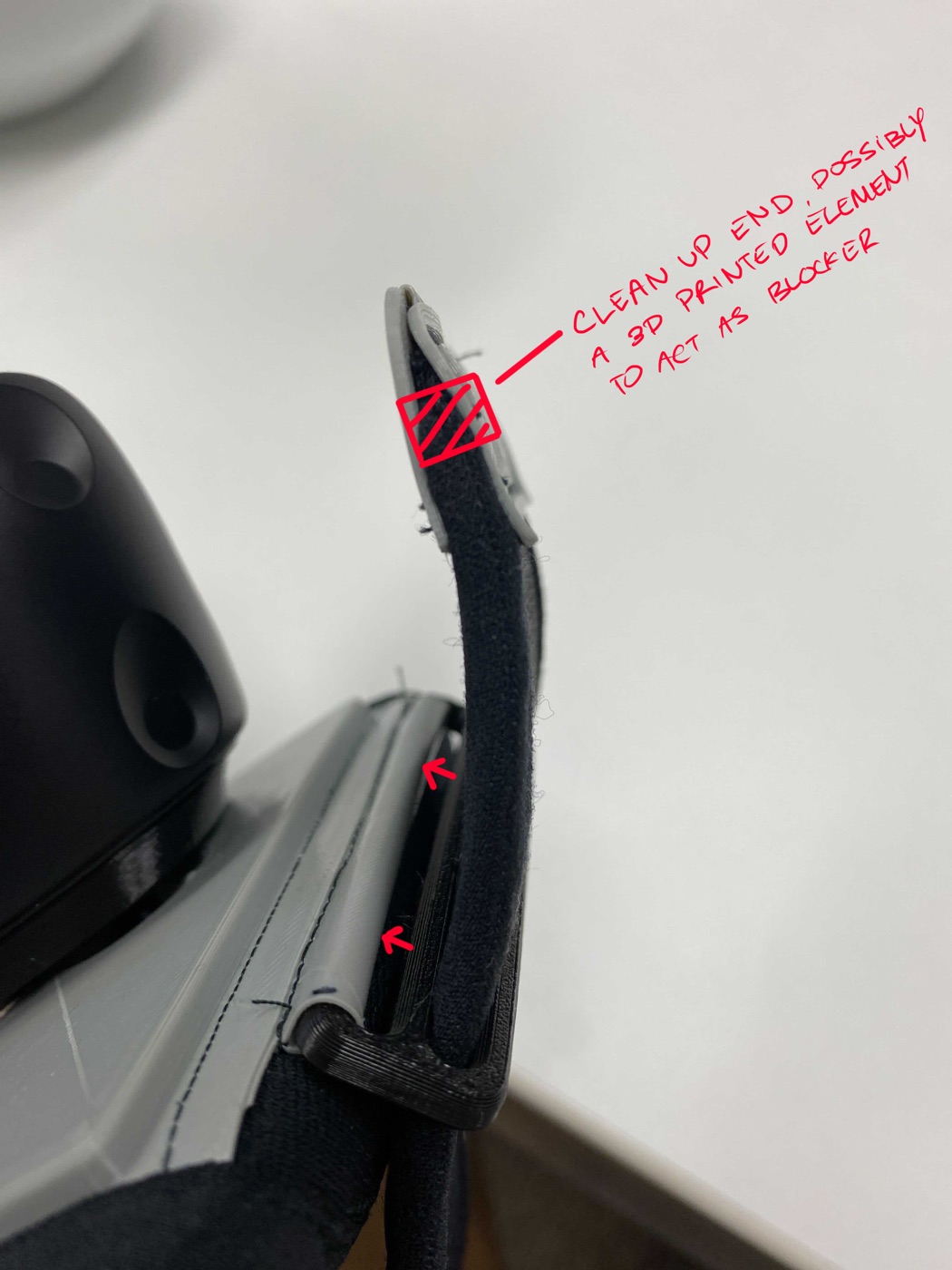 Annotated photo of a prototype strap end requesting a printed stopper